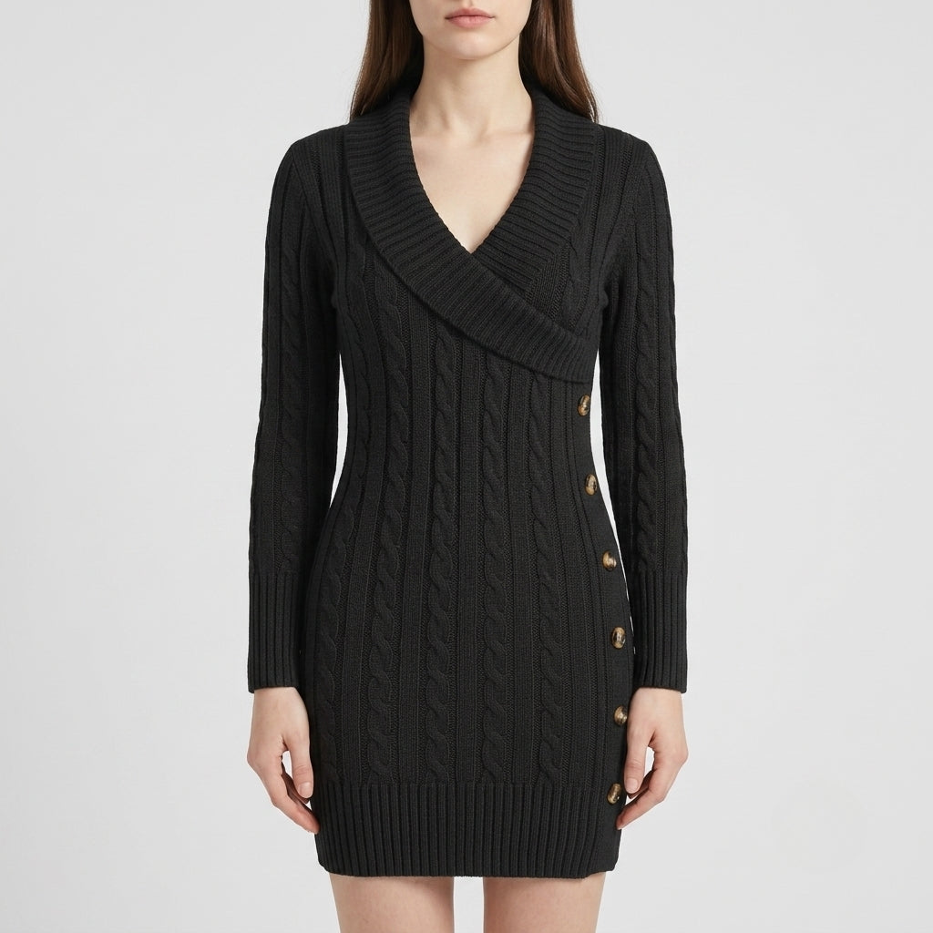 A woman wearing a black cable-knit wrap-style mini dress with a V-neck and decorative gold buttons on the side, photographed against a light gray studio background.