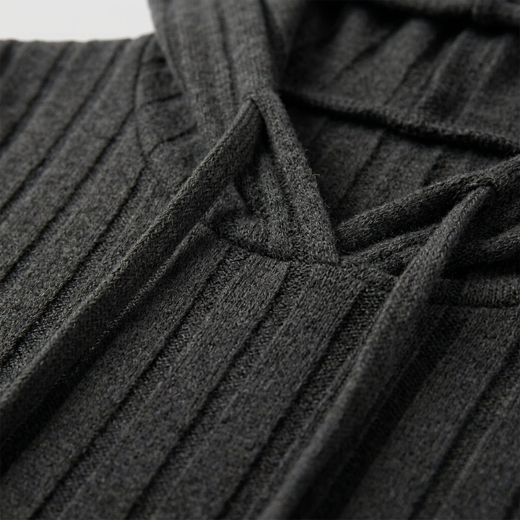 Close-up of a dark charcoal gray ribbed knit garment, showing the texture of the fabric and drawstring details.